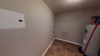 a small room with a refrigerator and a dryer in it